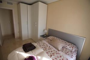 a bedroom with a bed with a bag on it at POSTIGUET BEACH in Alicante