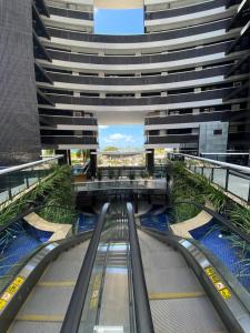 an escalator in the middle of a tall building at Landscape Beira Mar Meireles in Fortaleza