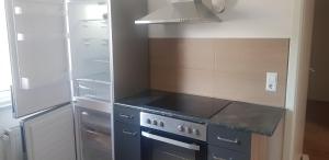 a kitchen with a stove and a refrigerator at Schnelle Vermietungen in Achern