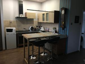a kitchen with a island with bar stools at Petra Apartman in Tapolca