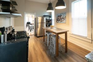 a kitchen with a table and a stainless steel refrigerator at 2360 Glenarm Place in Denver