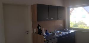 a kitchen with a sink and a window at Schnelle Vermietungen in Achern +5 photos