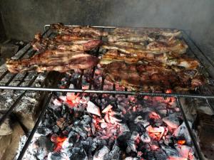 Un mucchio di carne che cuoce su una griglia di Villa Singola a Valledoria