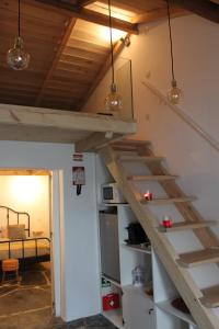 a room with a staircase in a room with a bed at Alma d'Outeiro in Monsaraz