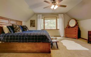 a bedroom with a bed and a ceiling fan at Lanfyne Ayr in Waynesville