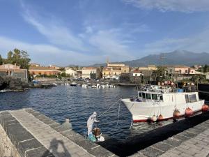 a boat is docked at a dock in a harbor at Le case di Carlotta & Giorgia in Pozzillo