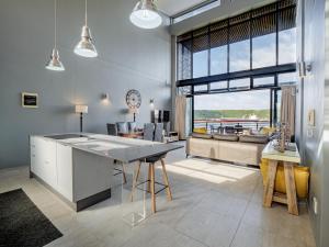 a kitchen and living room with a large window at Point Bay - Super Stylish for Less in Durban