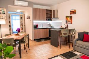 a kitchen and living room with a table and a couch at Borgo San Lorenzo Roma in Rome