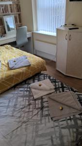 a bedroom with a bed and two rugs on the floor at The Winter Garden Suites in Blackpool