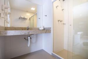 a bathroom with a sink and a shower at Flat 402 in Cabo Frio 700m from the beach in Cabo Frio +38 photos
