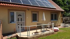 a house with solar panels on the roof at Keller Apartmanok in Hajdúszoboszló
