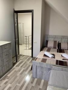a bedroom with a large bed and a large mirror at Villa MATE & Villa LUKA in Ureki