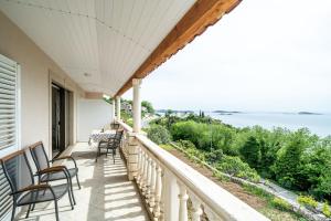 a balcony with chairs and a view of the ocean at Deluxe apartment in Mlini