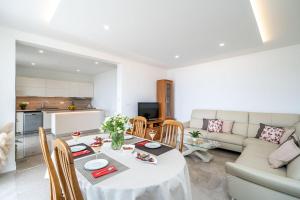 a living room with a table and a couch at Deluxe apartment in Mlini
