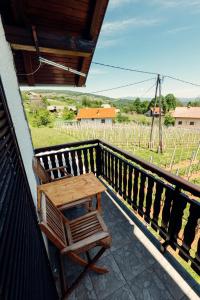 a wooden table and a chair on a balcony at Zidanica Bahor in Črnomelj