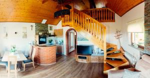 a living room with a spiral staircase and a living room at Zidanica Bahor in Črnomelj