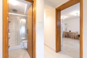 a bathroom with a toilet and a walk in shower at Apartments Stipančić in Krk