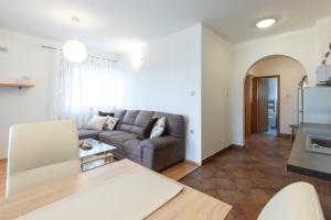 a living room with a couch and a table at Apartments Stipančić in Krk