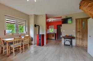a kitchen and dining room with a table and chairs at Domek Limba in Ustrzyki Dolne