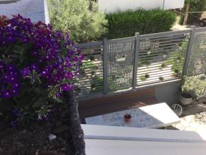 a bench with purple flowers and a red ball on it at Hotel Sweet Home in Neos Marmaras