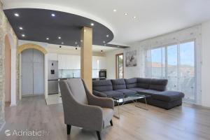 a living room with a couch and a table at Apartments Bagaric in Trogir
