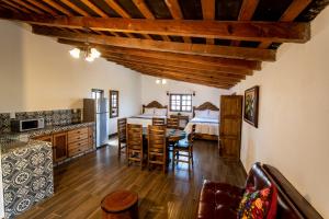 a living room with a dining table and a bedroom at La Diligencia Cabañas Campestres in Morelia
