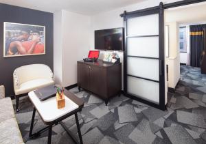 a room with a desk and a sliding door at Saint Kate - The Arts Hotel in Milwaukee