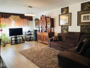 a living room with a couch and a flat screen tv at Avelana Apartment in Pärnu