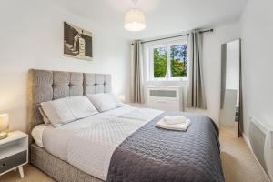 a bedroom with a large bed and a window at Saughton Suite in Edinburgh