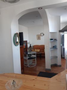 a living room with a table and a couch at L'ère du temps in Manheulles
