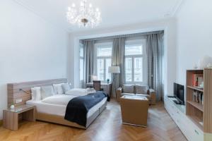 a bedroom with a bed and a living room at Vienna Residence, City Hall - Parliament in Vienna