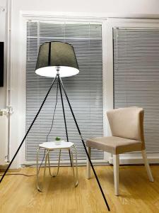 a lamp and a chair in a room with a chair and a table at Holiday Home Green House in Divčibare