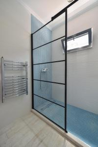 een douchecabine met een glazen deur in de badkamer bij WAVE 3 Promenada Apartments in Mamaia Nord – Năvodari