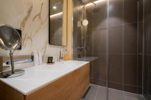 a bathroom with a sink and a shower at Vienna Residence, City Hall - Parliament in Vienna