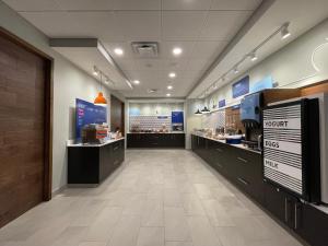 a lobby of a restaurant with a food counter at Holiday Inn Express & Suites - Ft. Smith - Airport, an IHG Hotel in Fort Smith