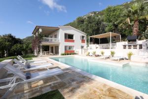 a villa with a swimming pool and a house at Ionian Garden Villas - Villa Sol in Benitses