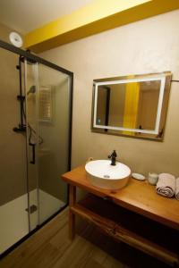 a bathroom with a sink and a shower with a mirror at les jardins de la sud in Lacanau +34 photos
