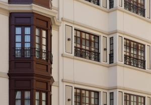 a facade of a building with windows and balconies at NUMA HOTEL BOUTIQUE in Gijón