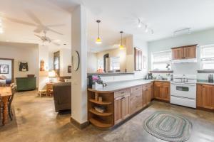 a kitchen with wooden cabinets and a living room at Mission Rock 2 in Ouray