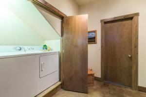 a bathroom with a wooden door and a staircase at Mission Rock 2 in Ouray