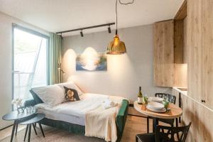 a living room with a bed and a table and a dining room at Kristina Apartments Sopot in Sopot