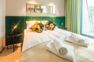 a bedroom with a bed with towels on it at Kristina Apartments Sopot in Sopot