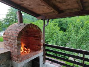 an outdoor brick oven on a deck at Holiday home RIVER NATURE in Jajce