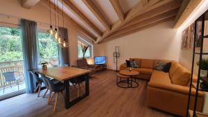 a living room with a couch and a table at Alpen Appartements Viehhofen in Viehhofen