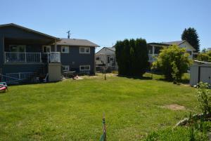 a yard of a house with a green lawn at Aasra Home in Kelowna