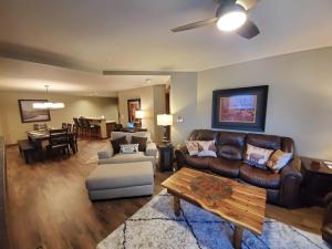 a living room with a leather couch and a table at Purgatory Lodge Unit 404 in Durango Mountain Resort