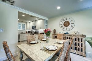 a dining room with a table and a clock on the wall at Kingston Arms 1st Floor in Sarasota
