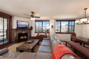 a living room with a couch and a fireplace at Purgatory Lodge Unit 302 in Durango Mountain Resort