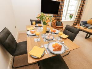 a dining room table with plates of food on it at Sail Away, 17 Union Mill in Whitby