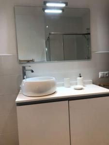 a bathroom with a white sink and a mirror at Playa de Carnota - SondeLira in Lira +42 photos